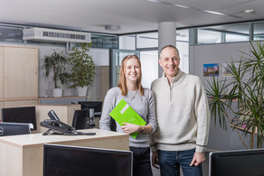Two friendly looking employees in an office
